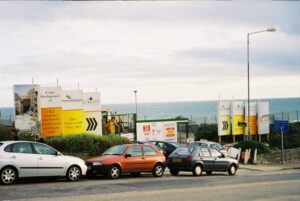 SZ1191 : Bournemouth: placards proclaim the coming of Honeycombe Beach, Boscombe