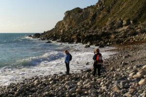 SY6971 : Walkers on the beach, Church Ope Cove