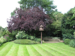 TQ2782 : The Holme, wooden dove house on pole in lawn